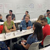 Students discussing around table